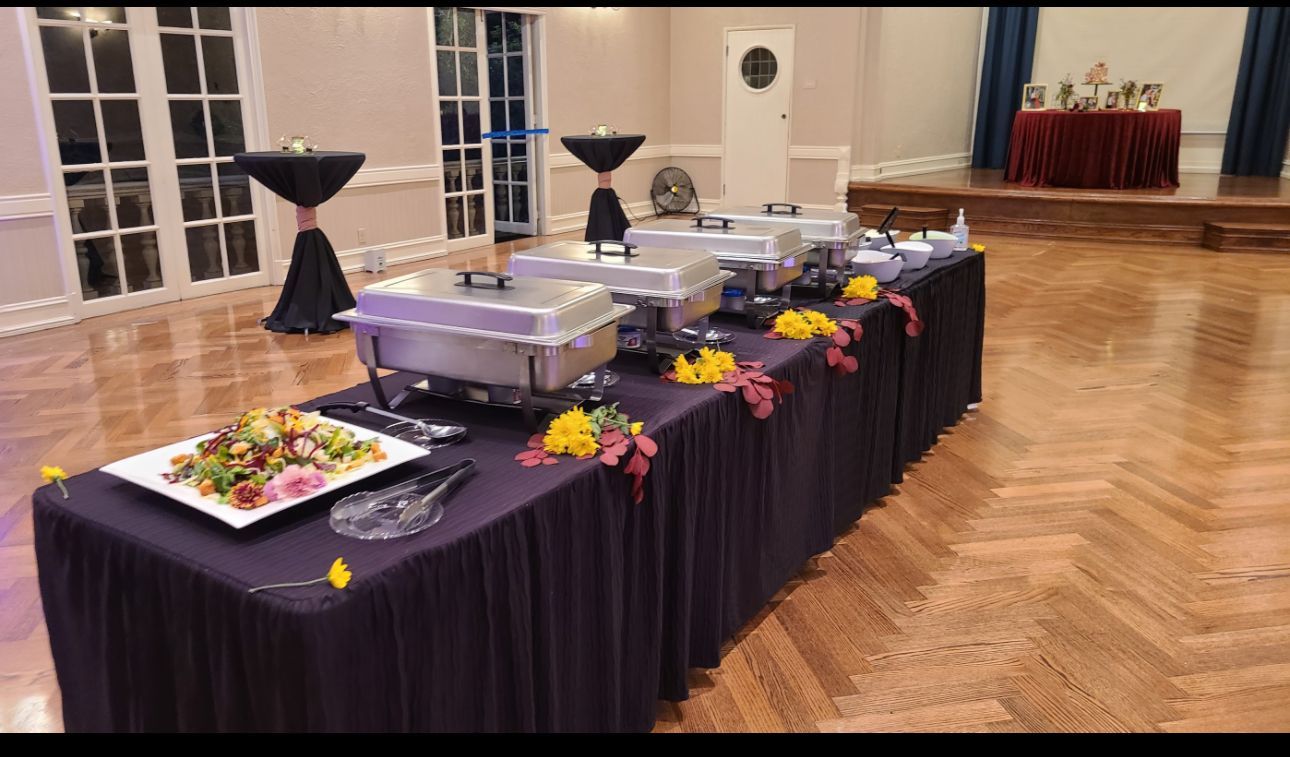 A long table with a lot of food on it in a room.