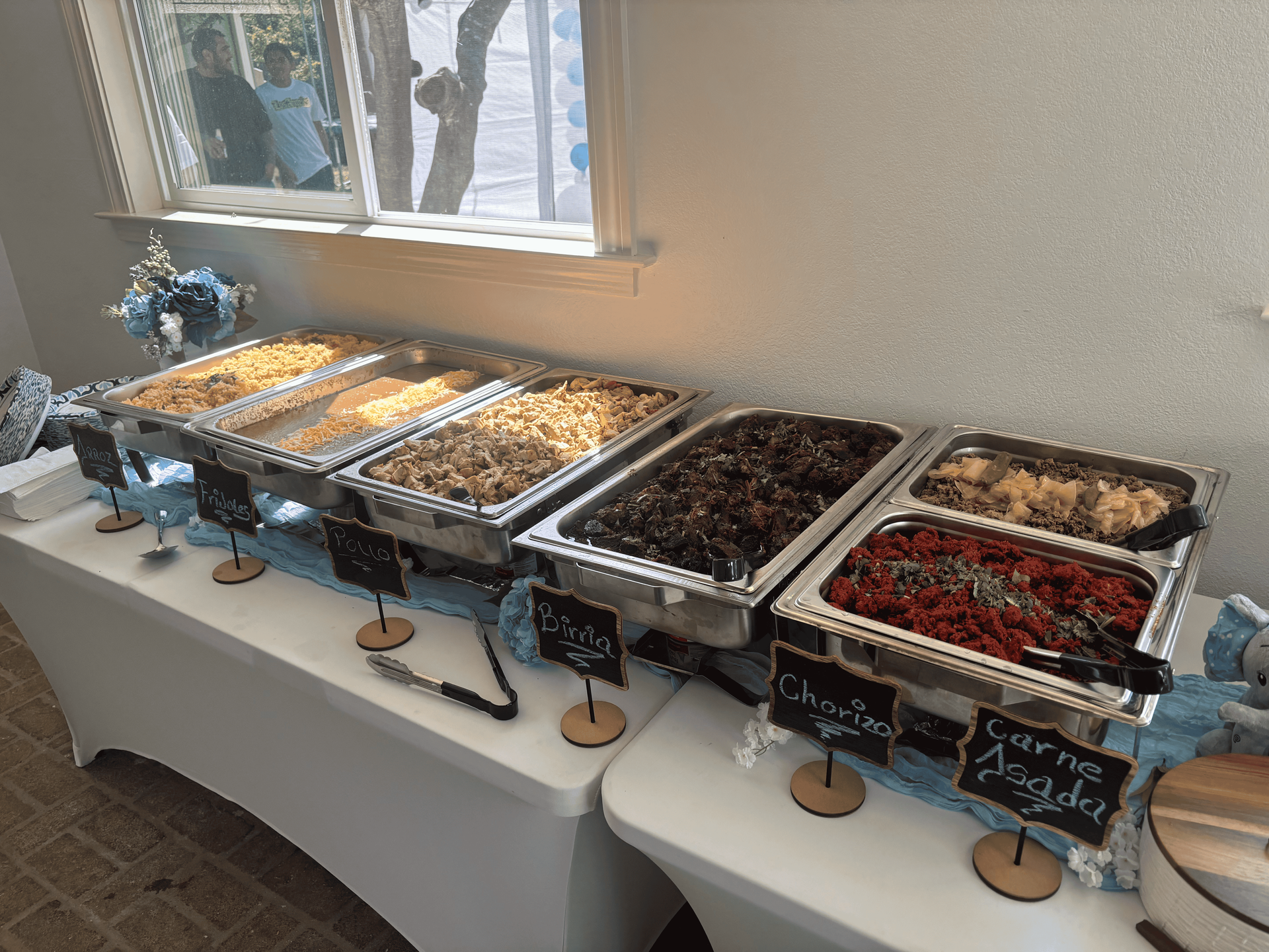 A buffet table with a variety of food on it.