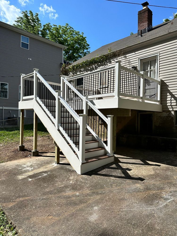 A white deck with stairs leading up to it