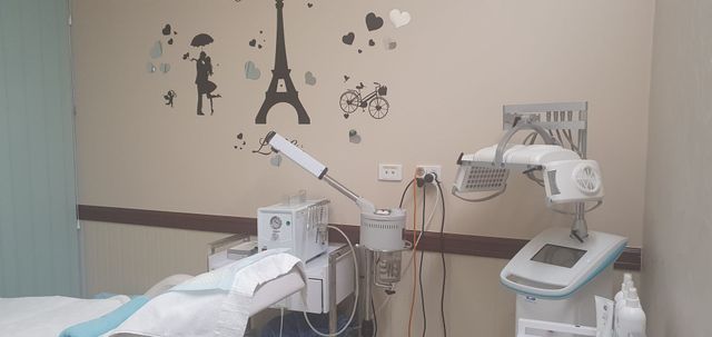 Examination room with treatment bed, equipment, and medical supplies  — Embrace Cosmetic Clinic in Bundaberg North, QLD