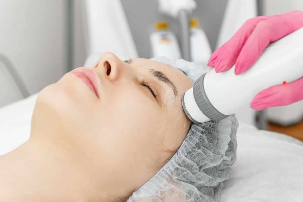 Woman Receiving Facial Treatment With Device; Spa Setting — Embrace Cosmetic Clinic in Bundaberg North, QLD