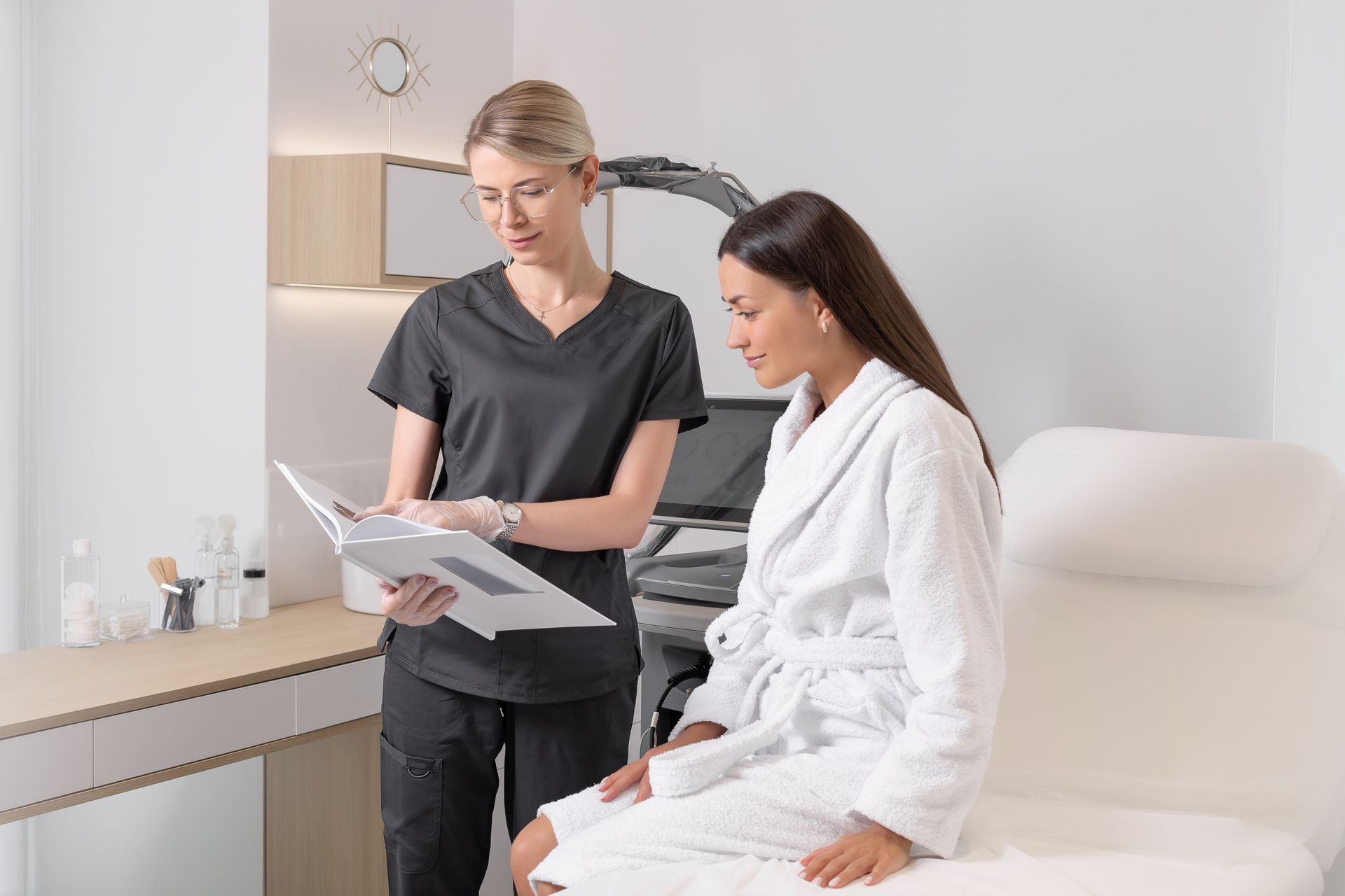 Medical staff reviewing records with a patient in a bright exam room