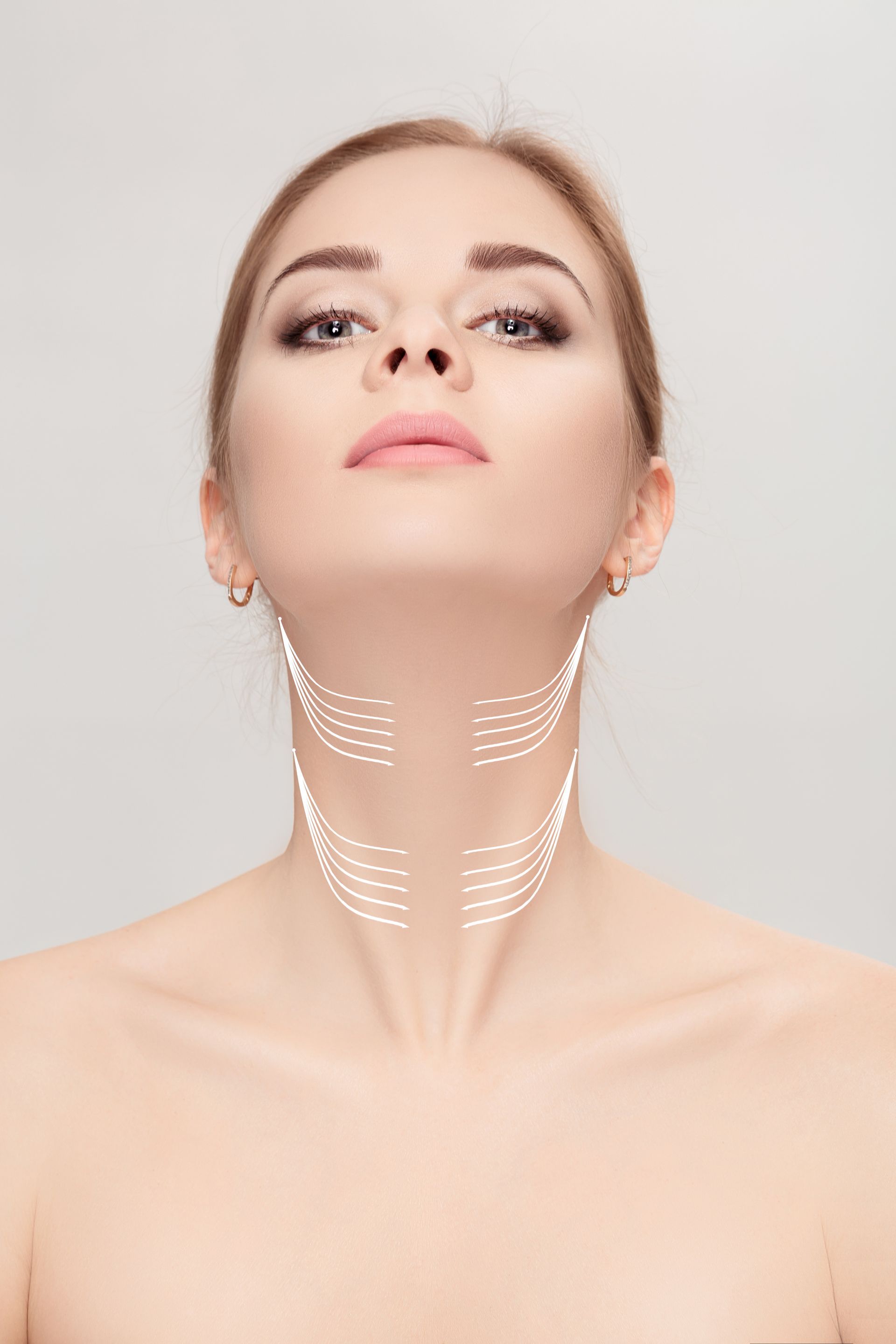 Woman's face and neck with dotted lines indicating a cosmetic procedure, neutral background.