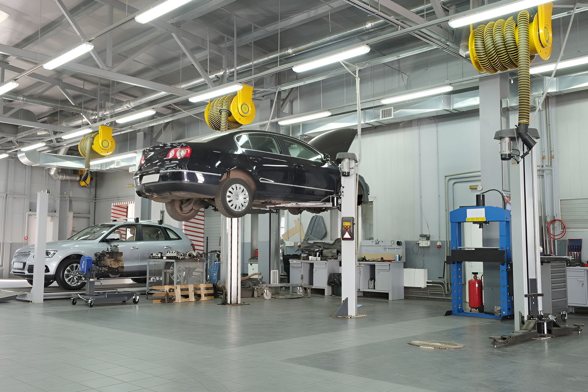 Cars on Lifts in a Brightly Lit Auto Repair Shop — Ultra Mechanics / EV Drive In Warana, QLD