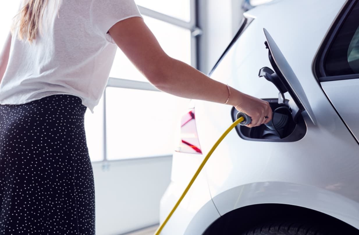 A Woman Is Charging Her Electric Car In A Garage — Ultra Mechanics / EV Drive In Warana, QLD
