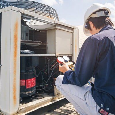 Technician is Checking Air Conditioner — Air Conditioning Service in Mackay, QLD