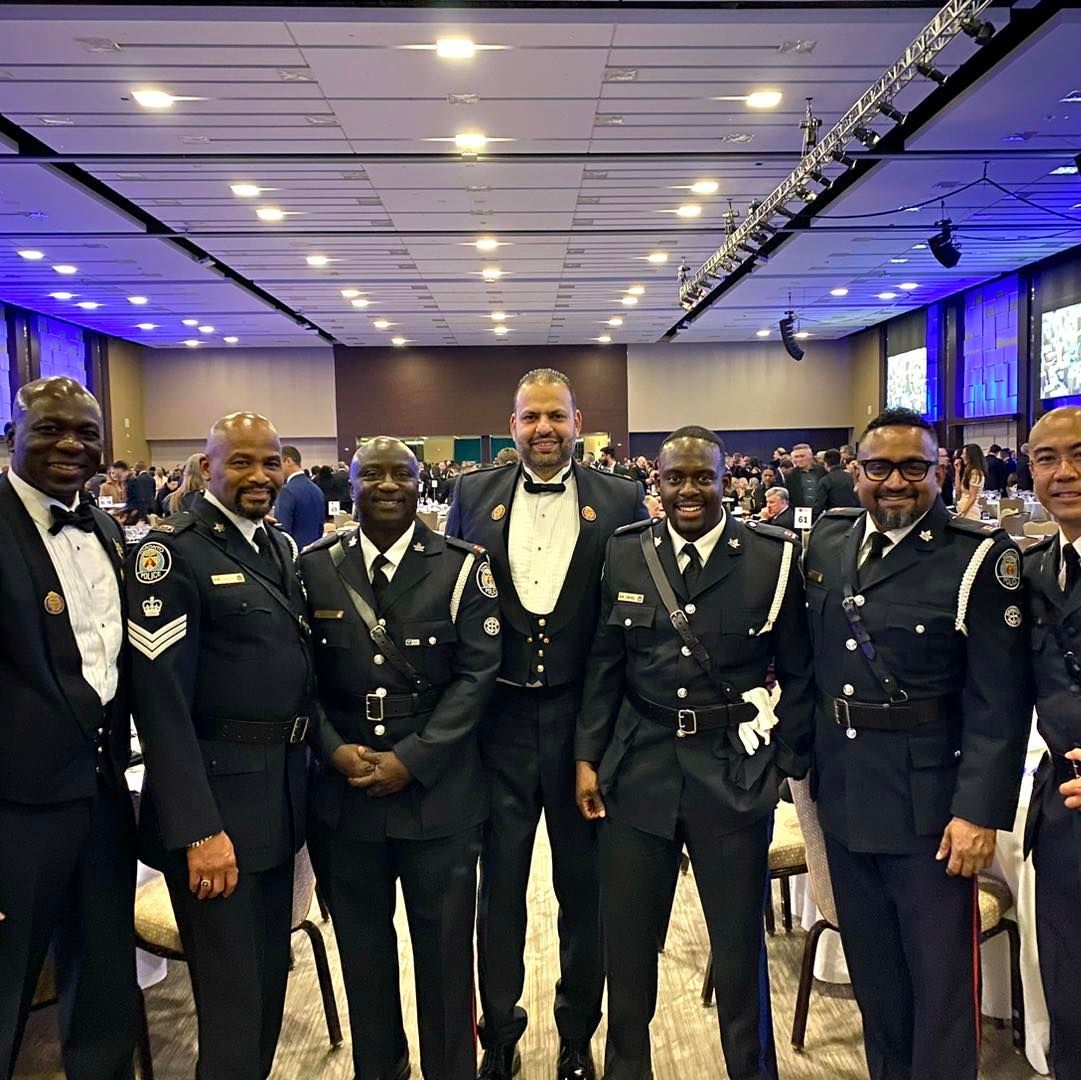 a group of men in military uniforms pose for a photo