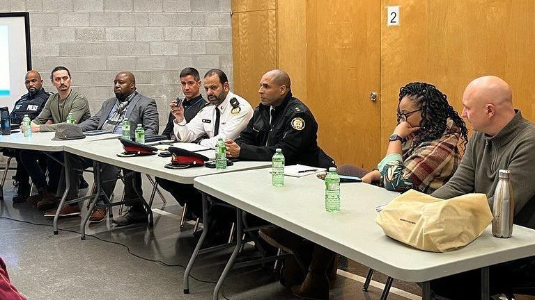 a group of people are sitting at tables in a room