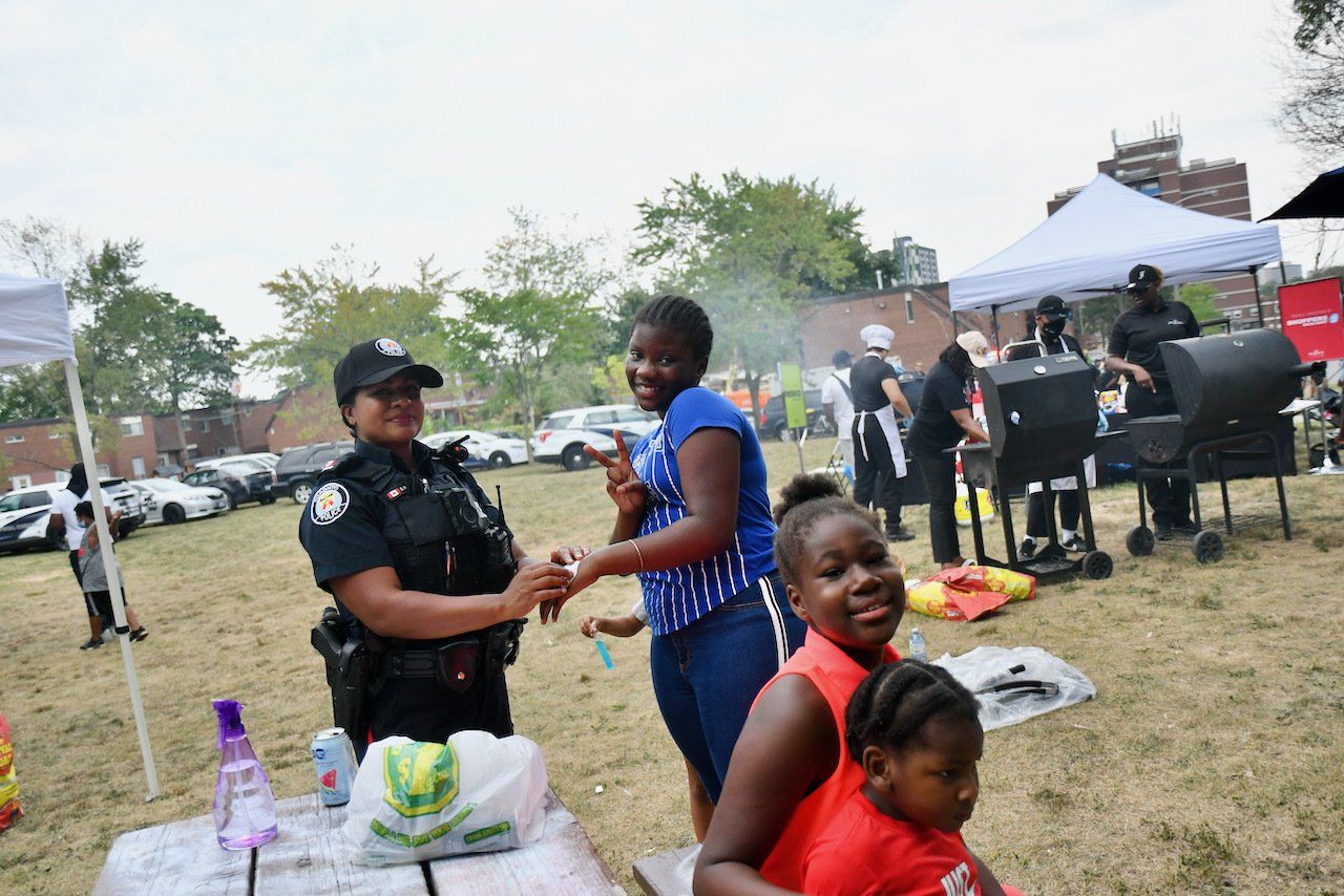Officer putting stickers on youth