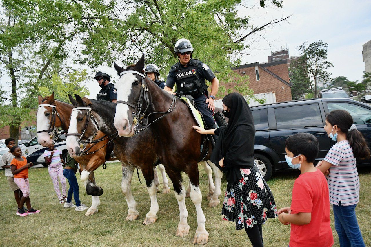 officers on horseback talking to people