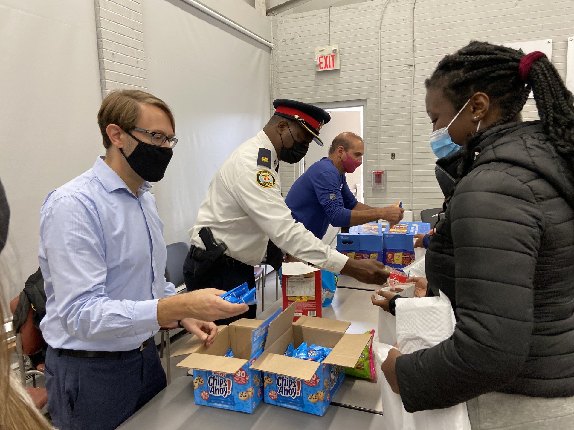 Tom and superintendent handing out treats