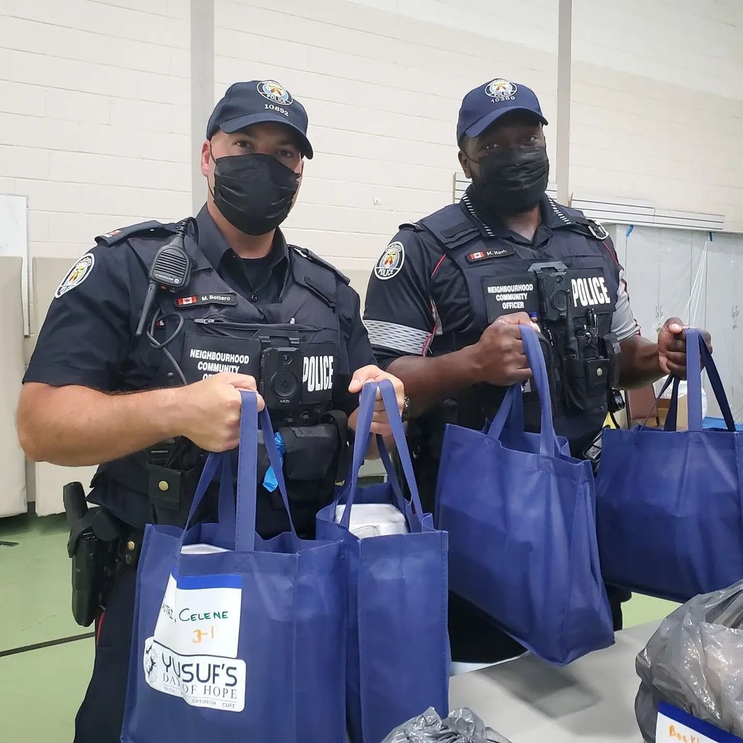 Officers holding bags of food