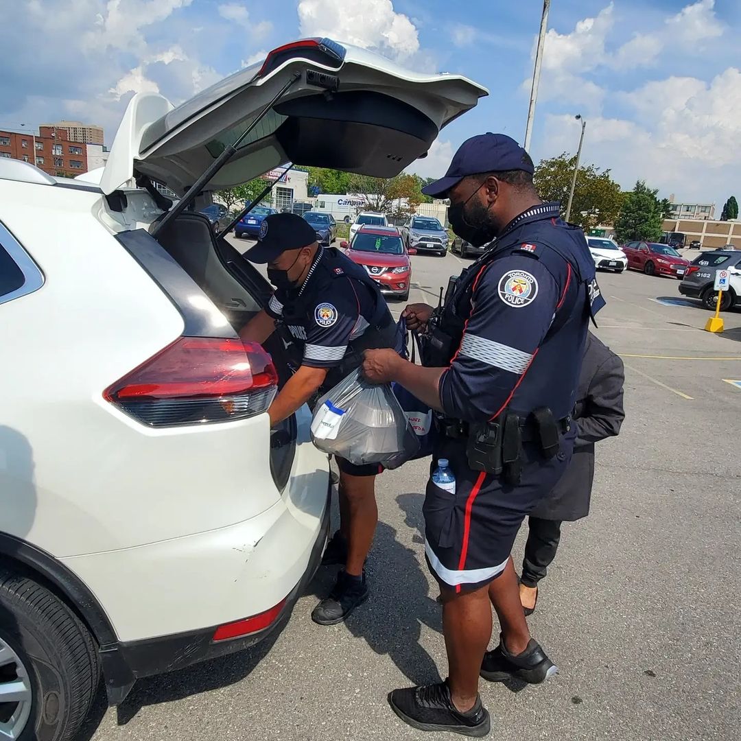 Officers loading food into vehicle