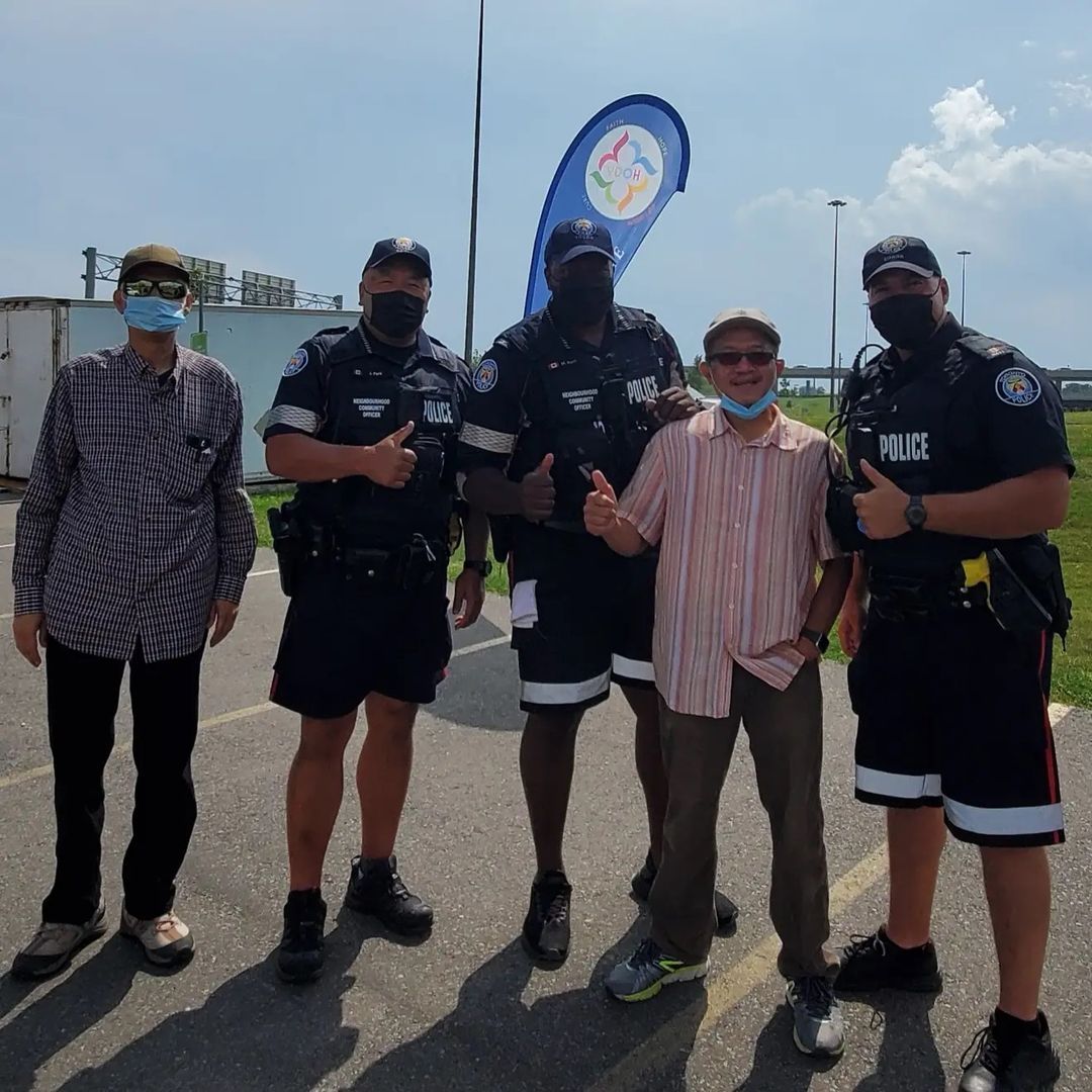 Officers taking pictures with volunteers