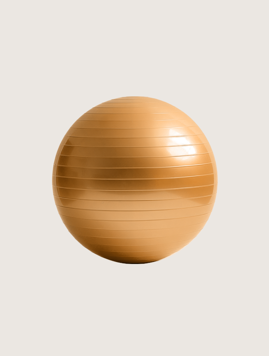 Tan exercise ball on a light background.