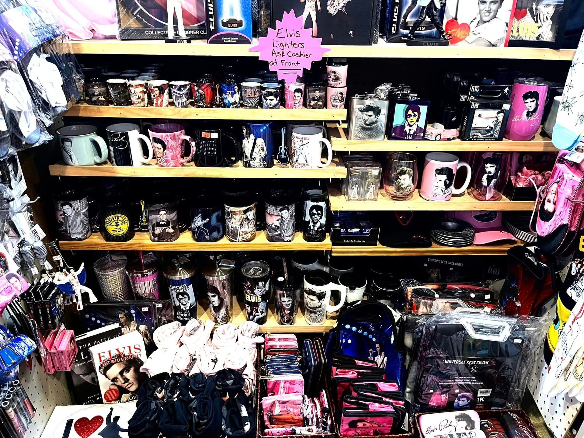Shelves in a store filled with merchandise including various themed mugs, boxed sets, and novelty gift items.