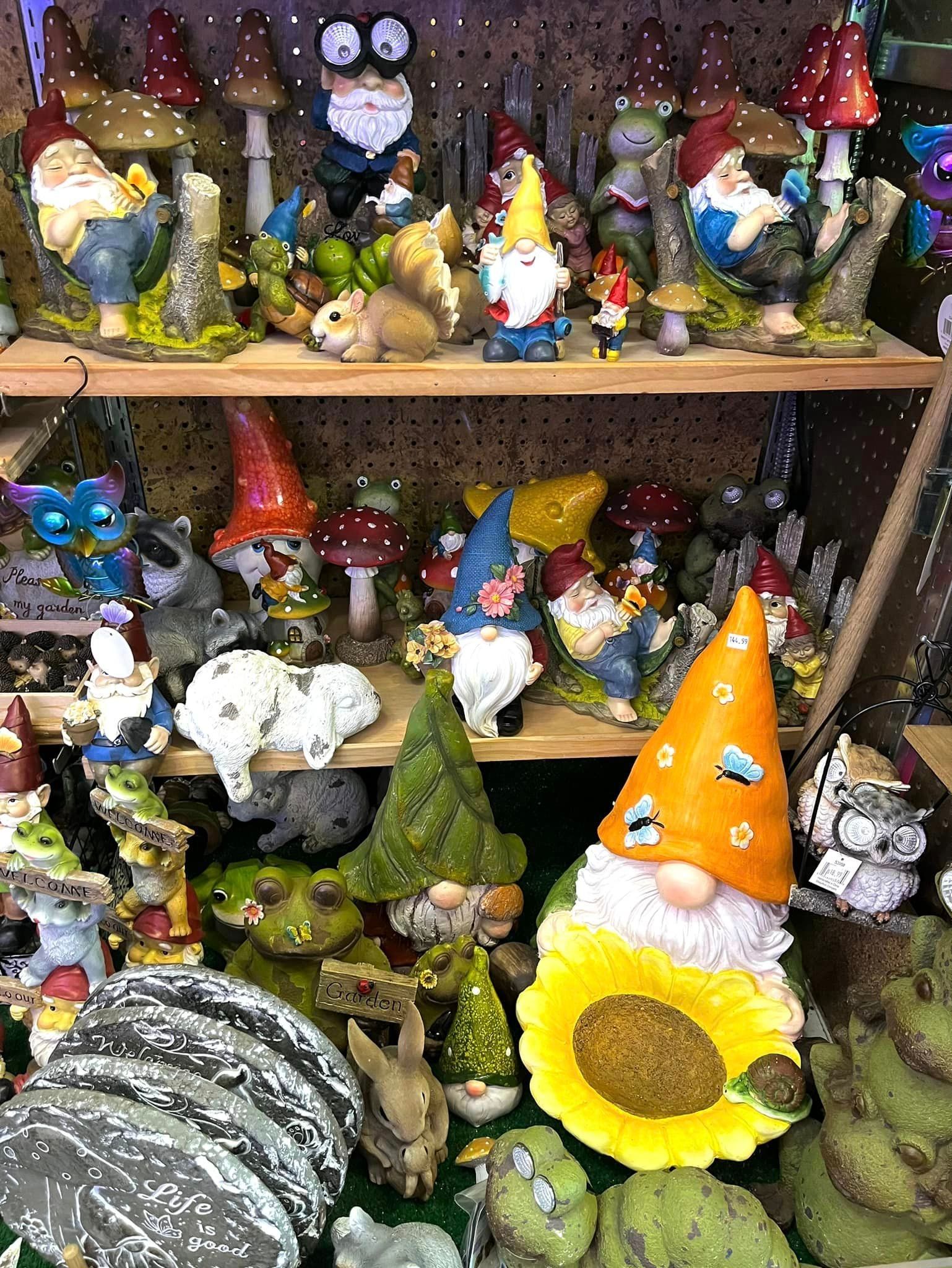 Shelves filled with various garden gnome figurines, colorful mushrooms, and decorative animal statues.