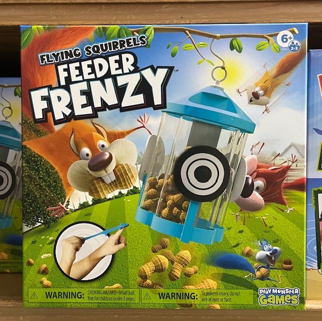 The board game Flying Squirrels Feeder Frenzy shows cartoon squirrels trying to reach a hanging bird feeder.