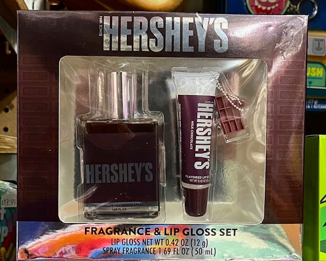 A Hershey’s branded fragrance and lip gloss gift set, featuring a perfume bottle and a lip gloss tube.