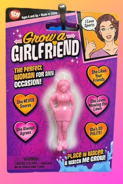 A pink toy figurine labeled 