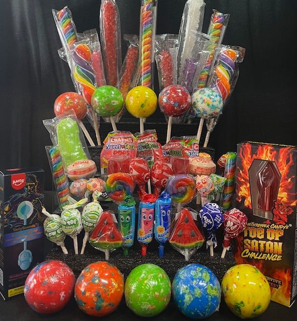 A display of various colorful lollipops and spherical candies, including a