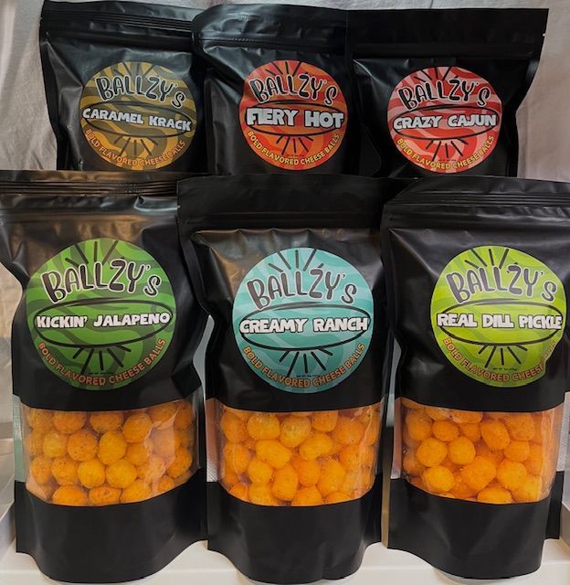 Six black bags of Ballzy's seasoned cheese puffs arranged in two rows, each featuring a specific flavor label.