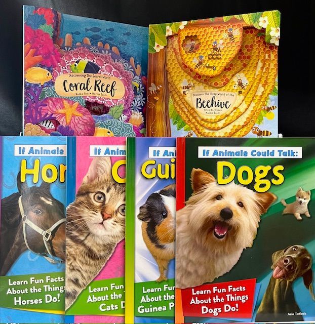 A collection of children's nature and animal books, including Coral Reef, Beehive, and the 