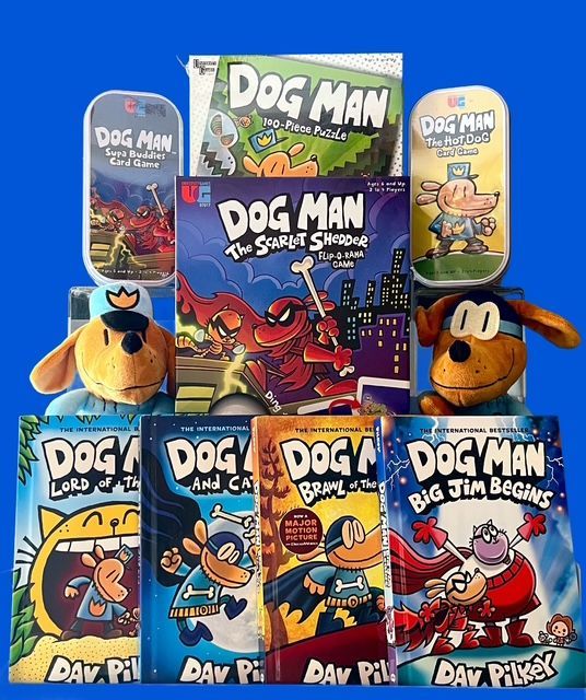 A collection of Dog Man books and two plush toys arranged against a solid blue background.