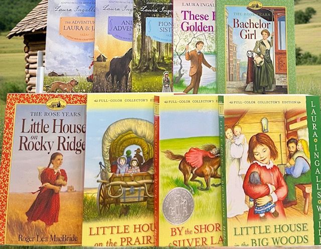 A collection of nine Laura Ingalls Wilder books displayed in two rows, with illustrations of the stories on their covers.