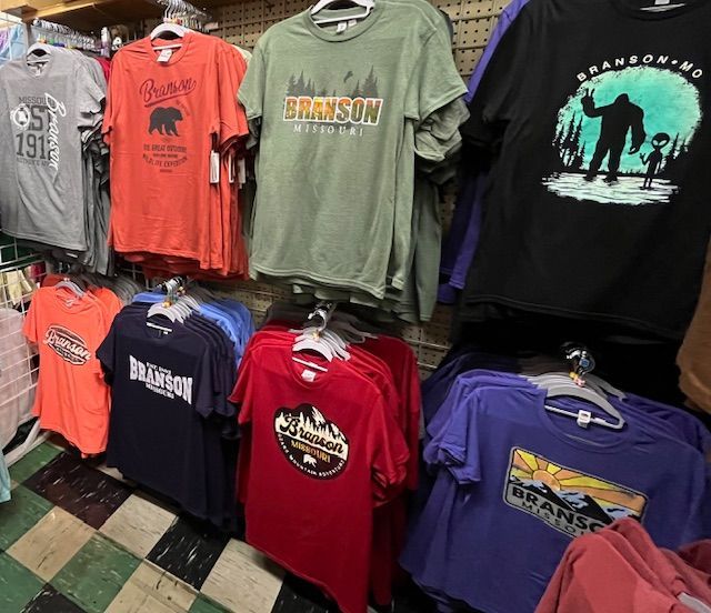 A retail display of assorted t-shirts featuring