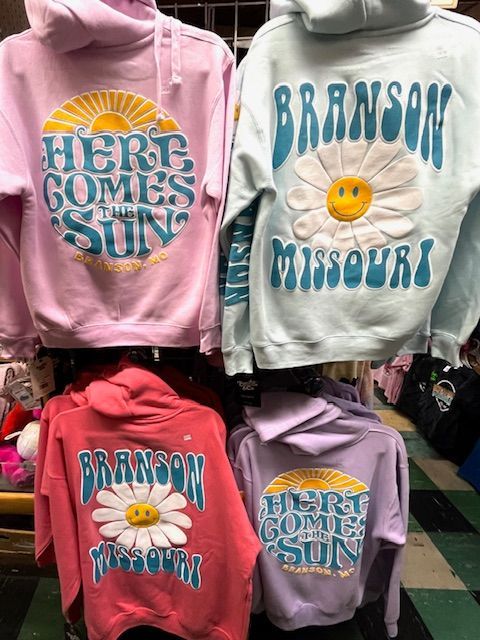 Four hooded sweatshirts in pink, blue, red, and purple featuring