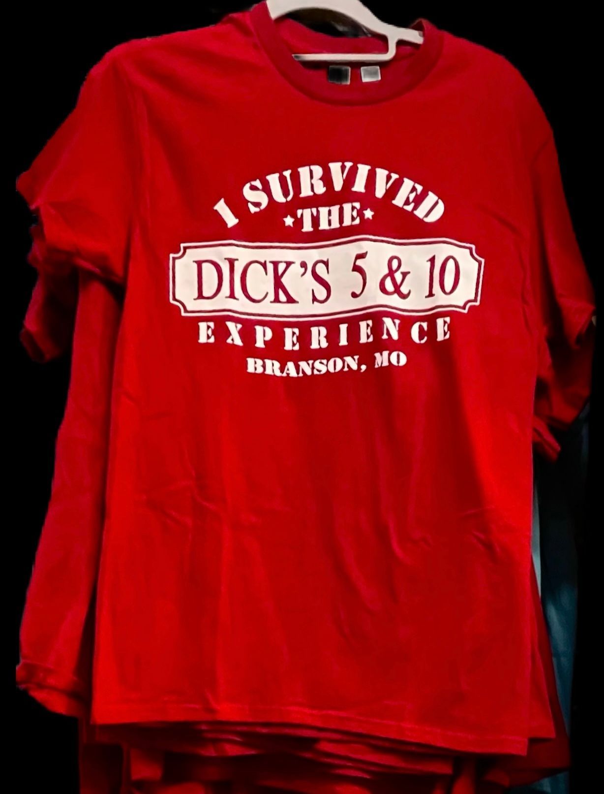 A red t-shirt on a hanger with white text that reads