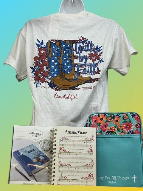 A white t-shirt with a cowboy boot graphic, a spiral notebook featuring 