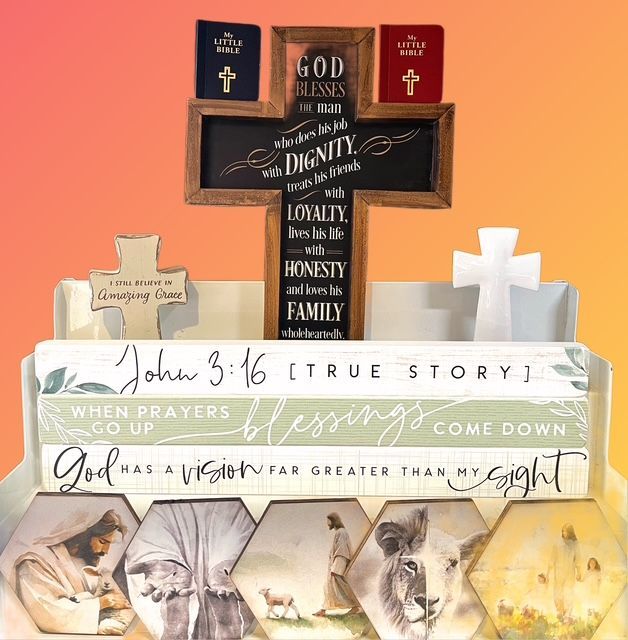 A collection of religious decor including a cross, books with scripture, and hexagonal art panels depicting scenes of Jesus.