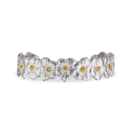 Un anello d'argento con dei fiori su uno sfondo bianco.