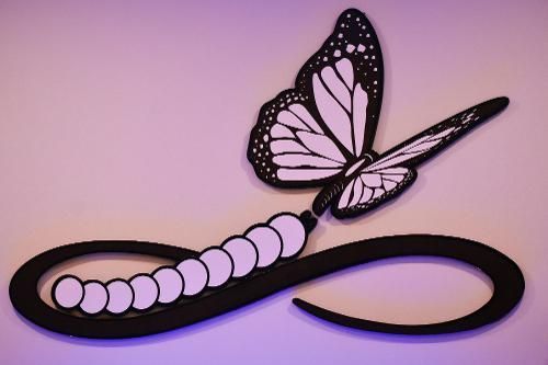 A black and pale purple infinity symbol, with the left loop formed by a caterpillar and a butterfly perched on the right.