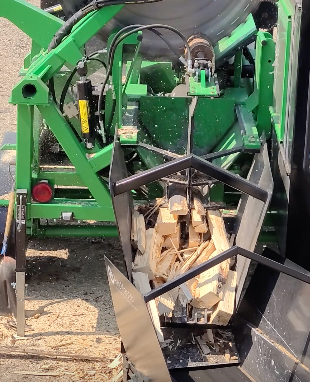 Close-up of a Firewood Processing Machine splitting logs into uniform firewood pieces.
