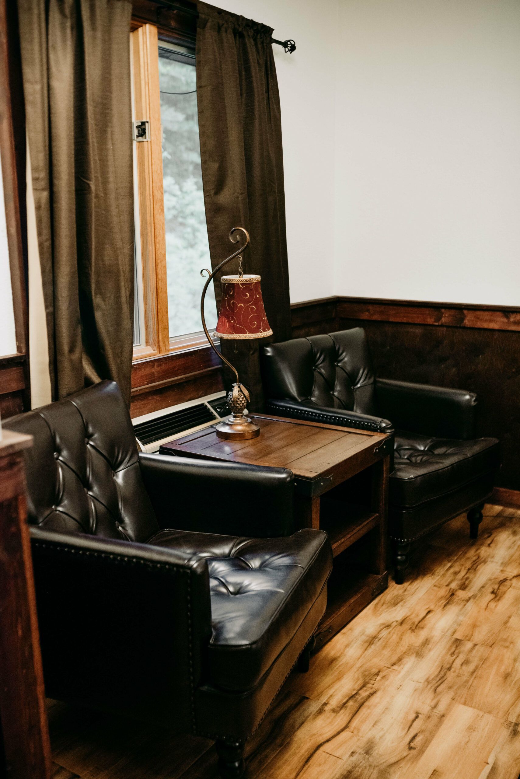 There are two chairs and a table in the room.