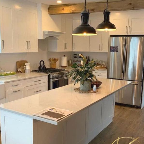 A kitchen with white cabinets and stainless steel appliances