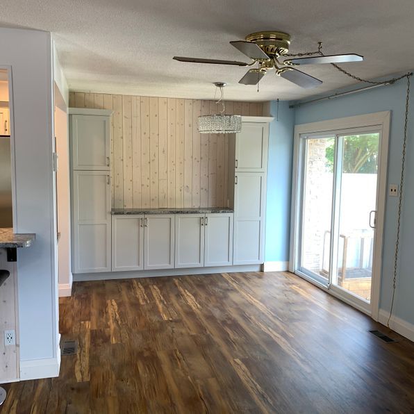 A living room with hardwood floors and a ceiling fan