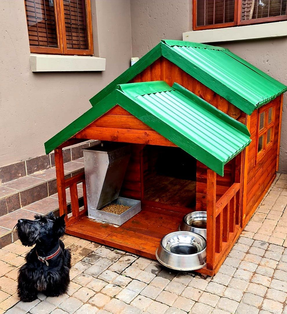 A wooden dog house with a green roof from Pets and the City in Pretoria East.
