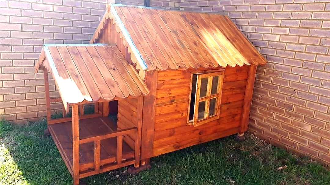 A wooden playhouse with a porch available from Pets and the City in Pretoria East.