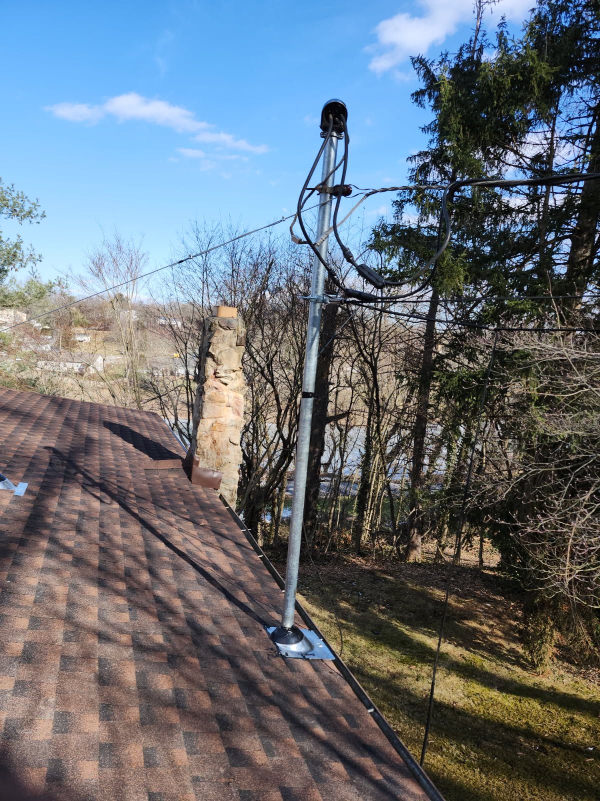 A roof with a chimney and a telephone pole on it