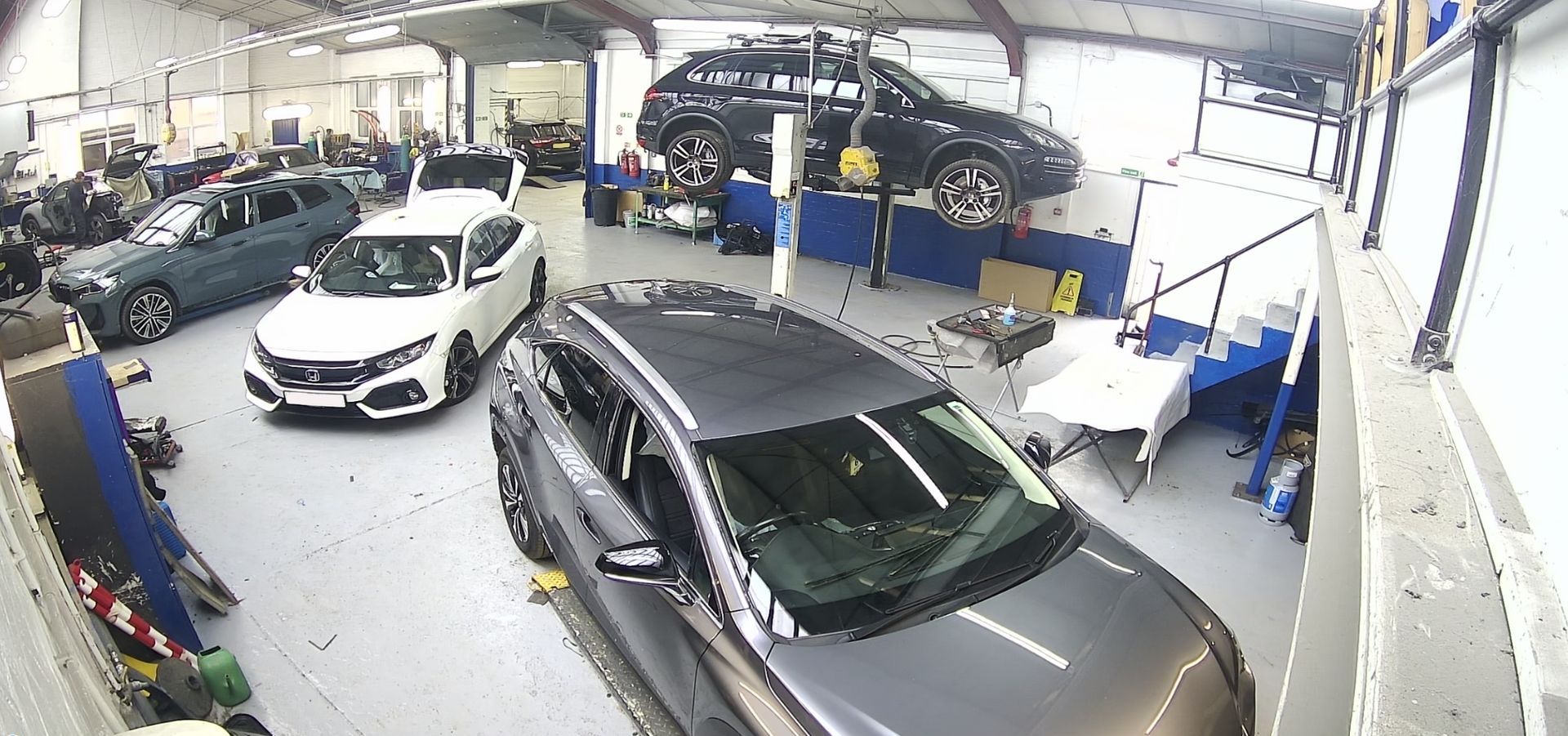A lot of cars are parked in a garage.