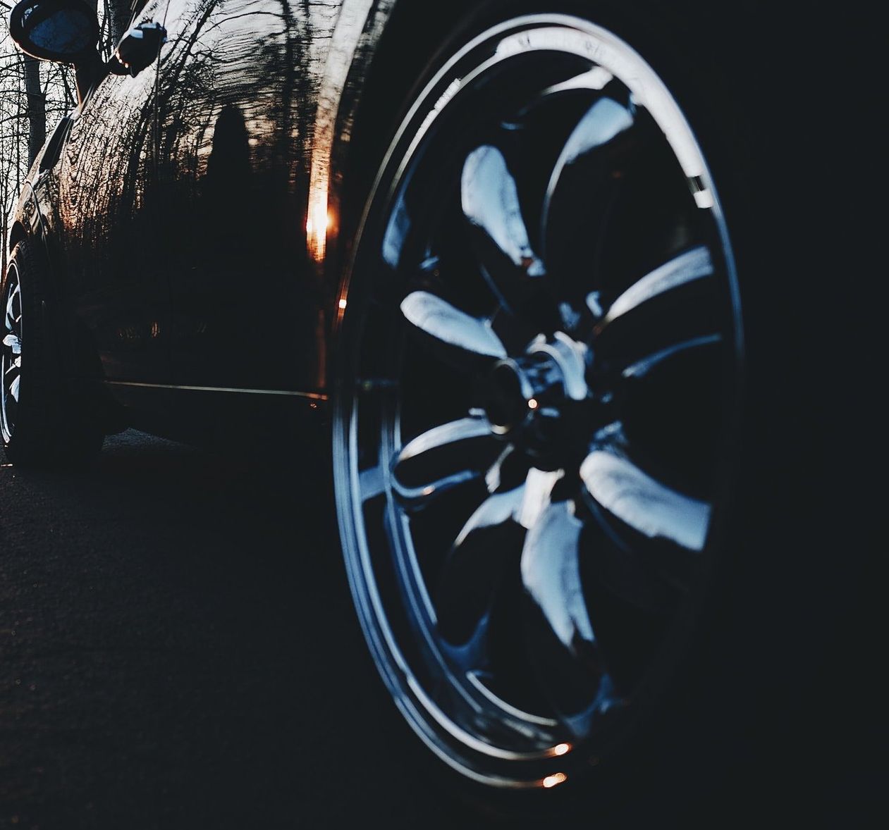 A close up of a car wheel in the dark