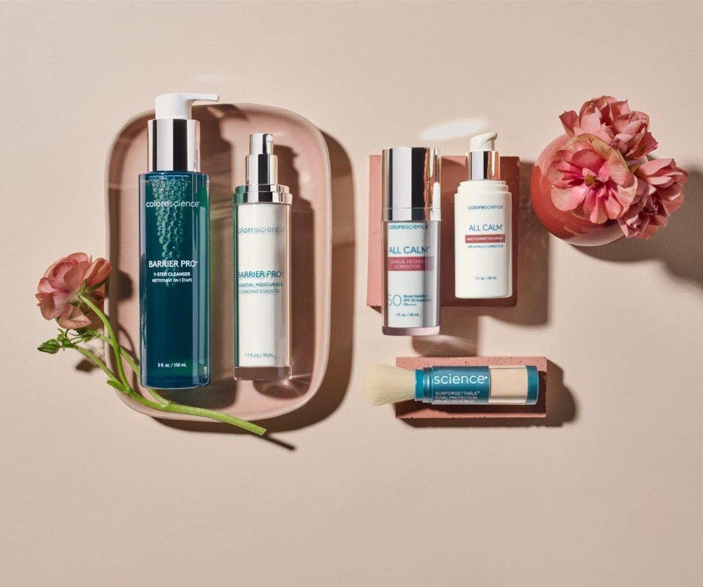 A bunch of bottles of cosmetics are sitting on a tray on a table.