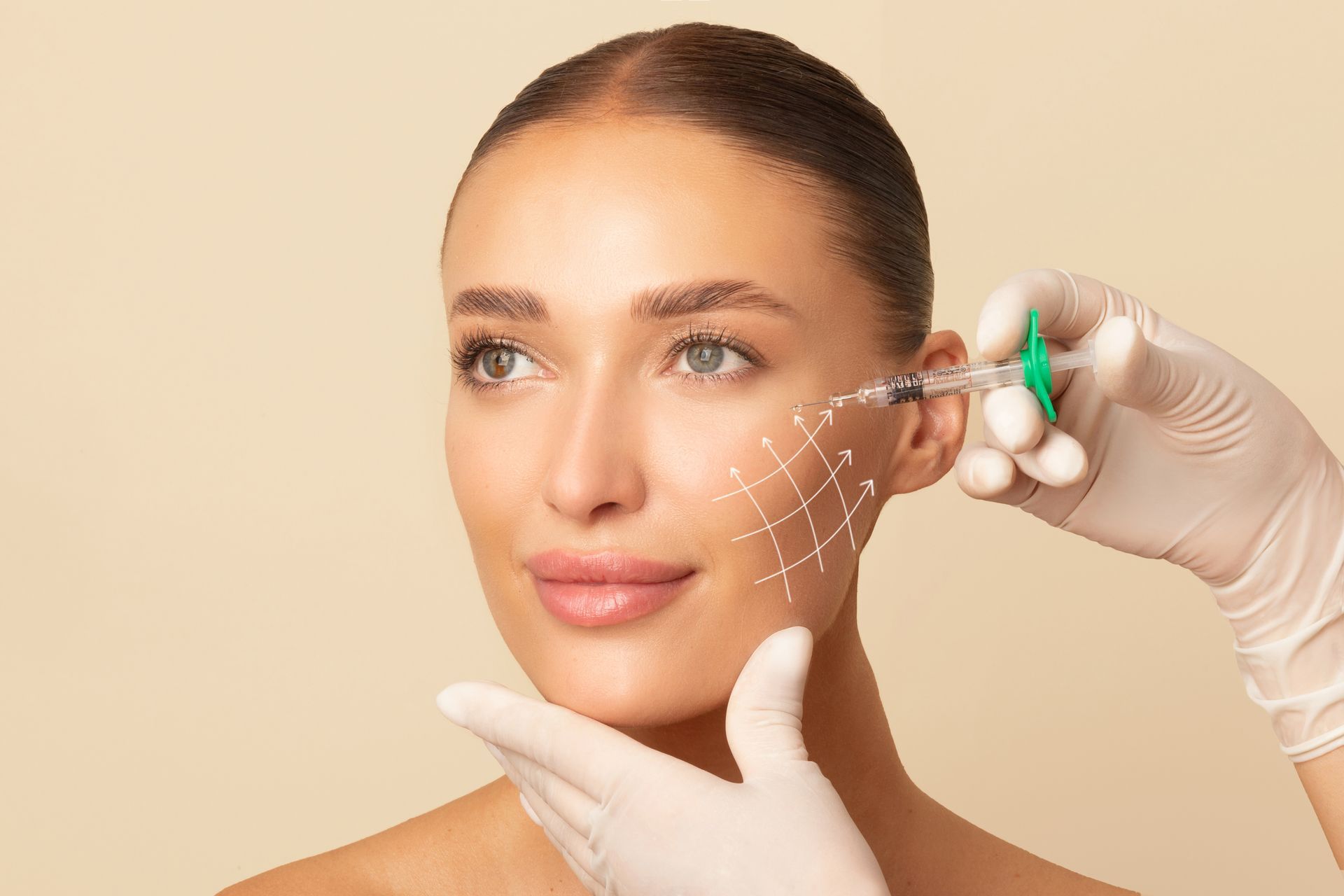 Cosmetic injection being administered to a woman's cheek with a gloved hand in a clinical setting