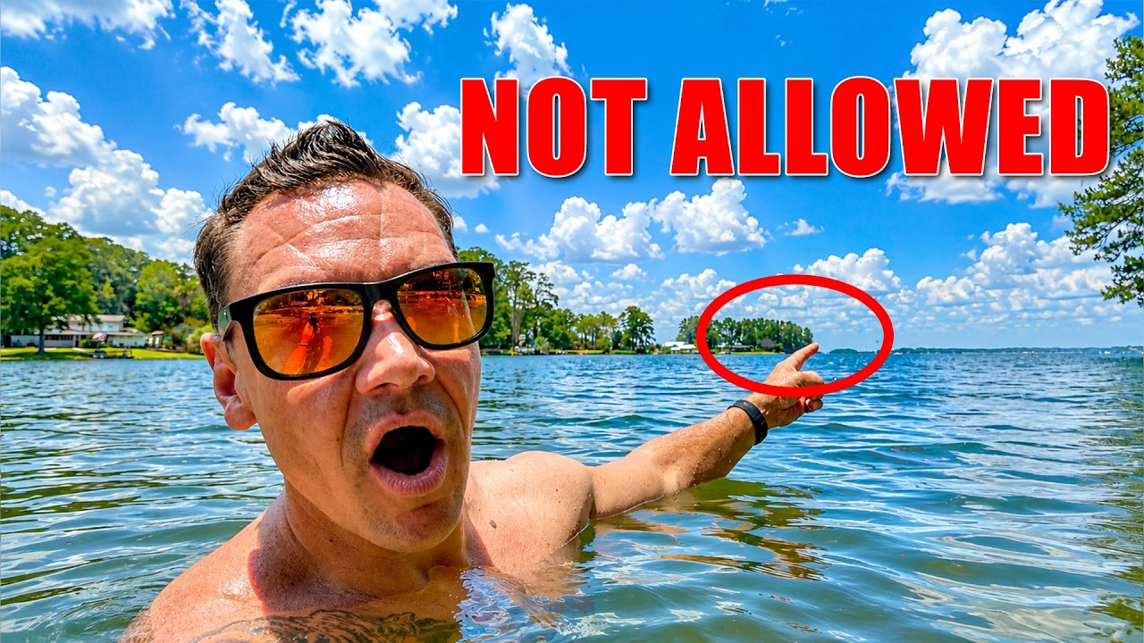 Swimmer in sunglasses in lake pointing at a red-circled area, with bold red “NOT ALLOWED” text above