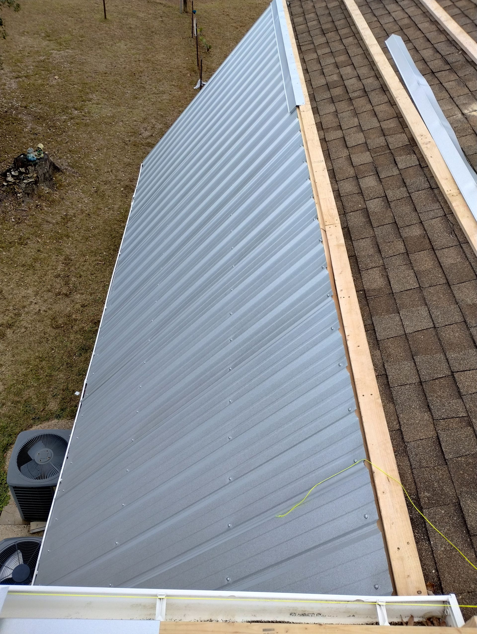A metal roof is being installed on a house.