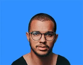 Man wearing glasses, with a buzz cut, and a serious expression. Set against a blue background.